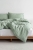 pościel lniana sage green na łóżku moana 650x975.jpg